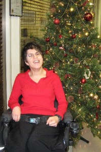 Employ-Ability Participant Lucy posing in front of a Christmas Tree