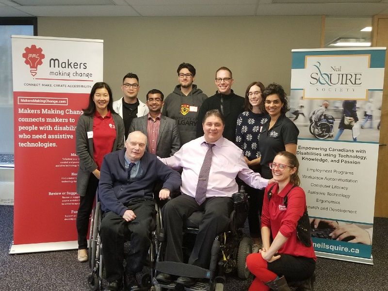 A group photo against a backdrop of Neil Squire Society and Makers Making Change banners