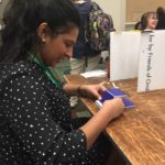 Piriya learning to build an inexpensive phone stand made of corrugated plastic