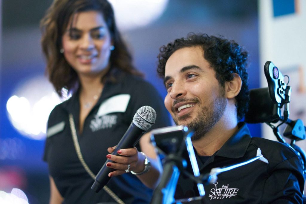 Omar speaking with Shelina Dilgir, Associate Director of Development, holding up the mic