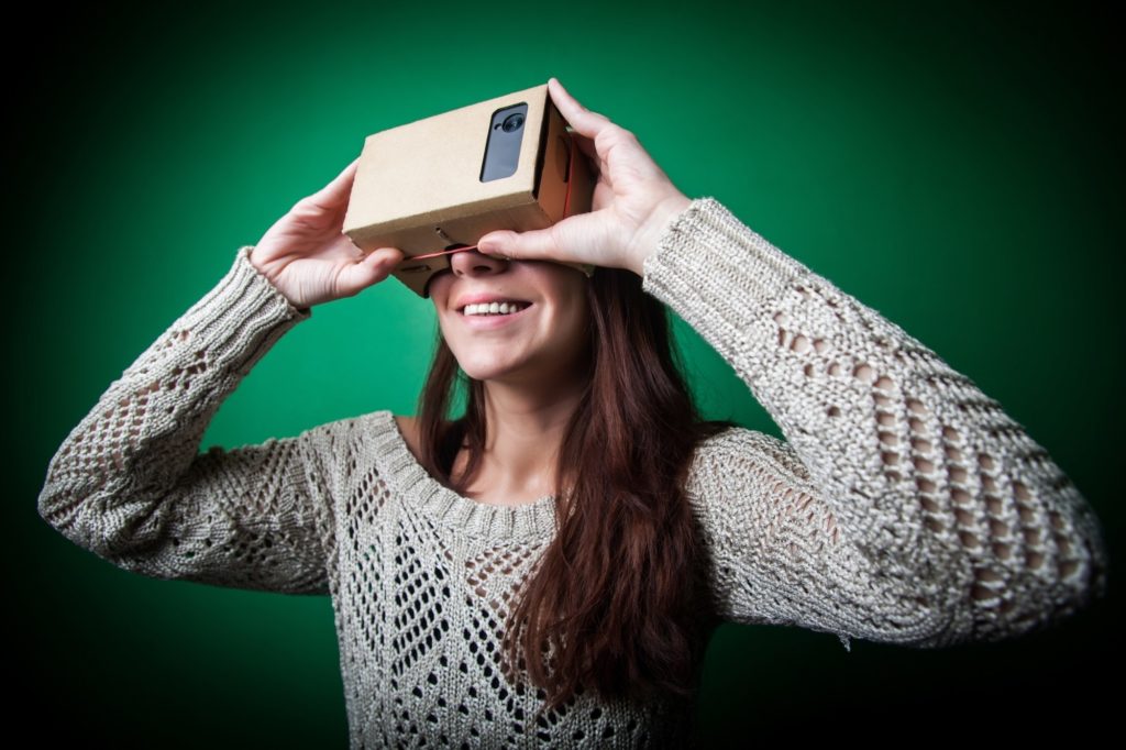 A woman using Google Cardboard