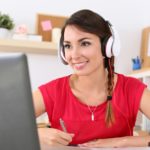 Woman with headphones at a computer