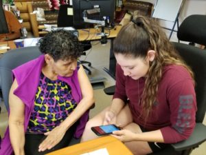 Vanessa (right) tutoring a Band Elder on a smartphone