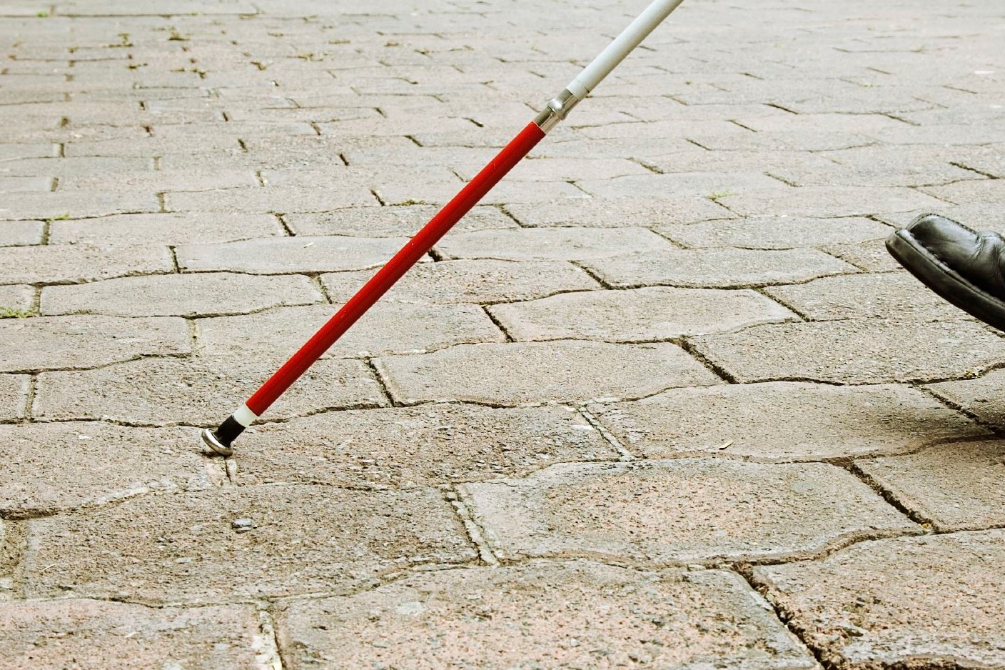 A stock image of a person using a white cane