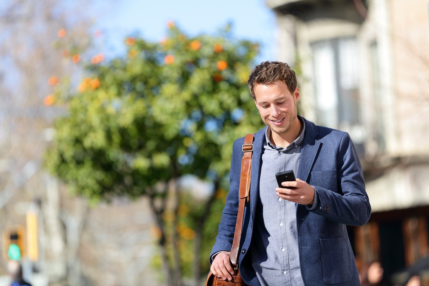 Man walking on the street looking at his phone