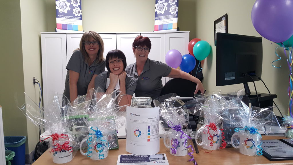 Staff behind a table of goodies