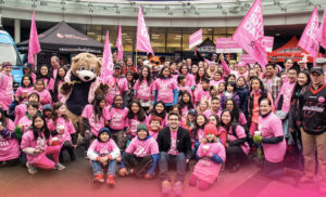 crowd wearing pink shirts