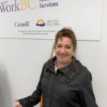 Karen in front of a WorkBC Assistive Technology Services sign