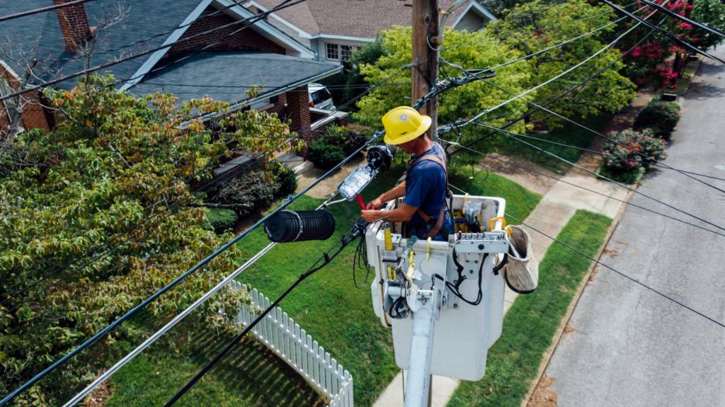 stock image of man repairing electrical wires