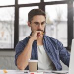 man concentrating on his computer