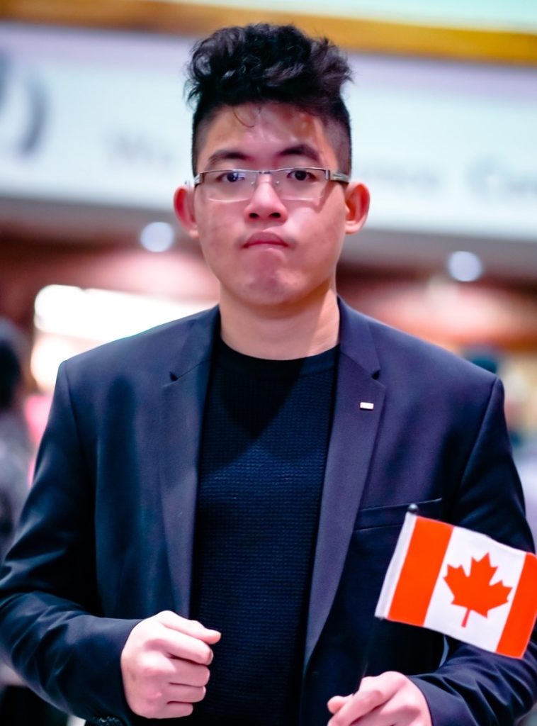 Steven holding up a small Canadian flag