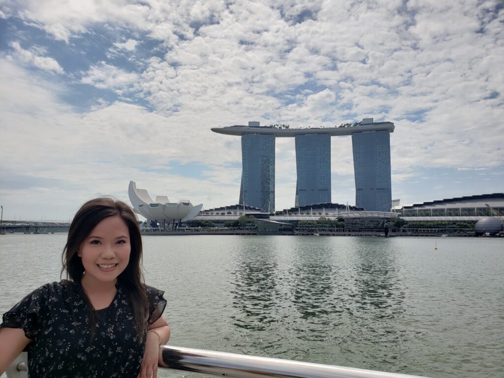 Alice posing with the Marina Bay Sands in Singapore in the background