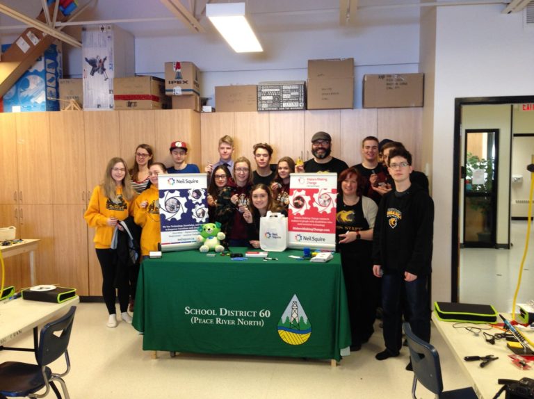 A group of 15 students posing with teachers after a Makers Making Change switch buildathon