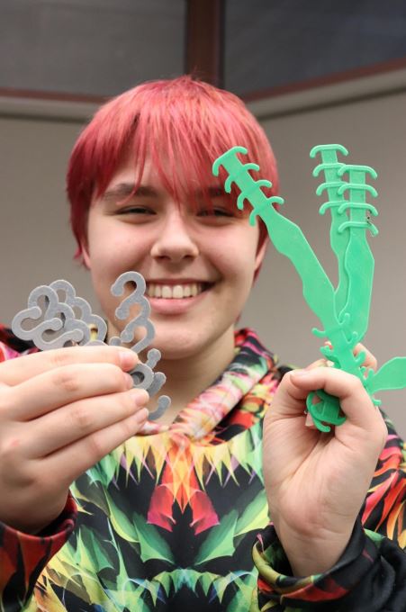 Grade 12 student Natasha shows off ear savers that she has printed