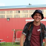 Tyler Fentie smiling in front of a building