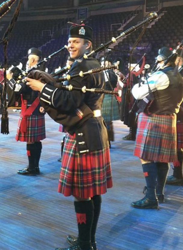 Stephen Moyer playing the bagpipes in a pipe band