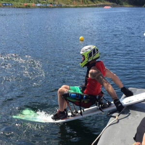 Blake hopping off a boat on his waterskis