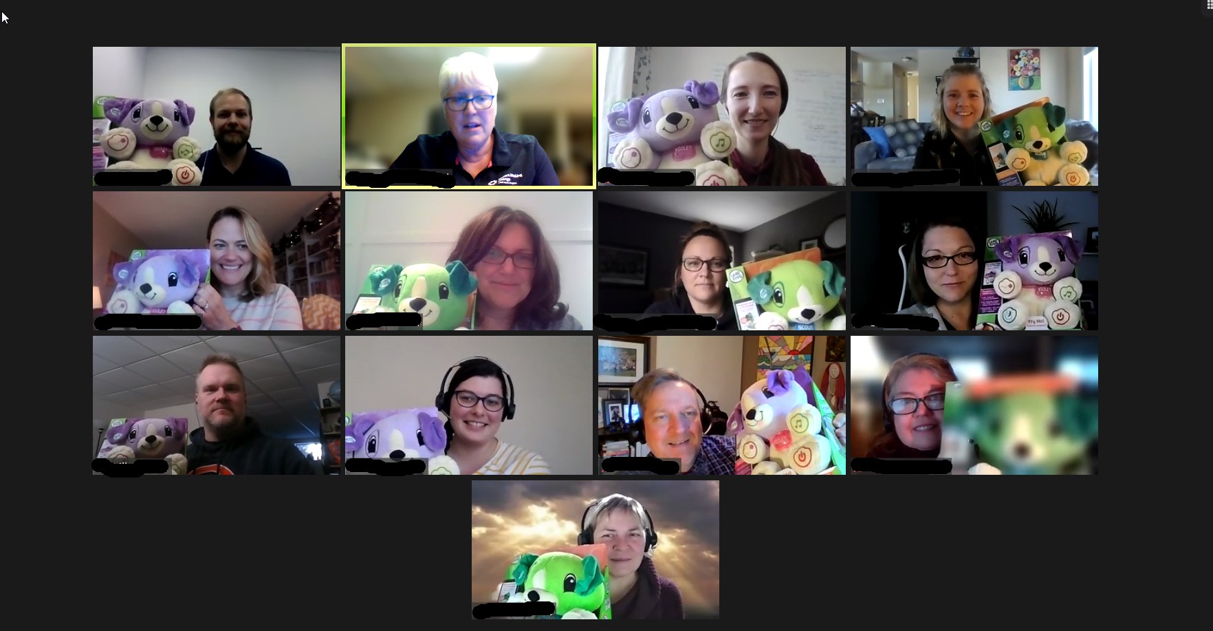 a screenshot of the build held over a Zoom meeting. Everyone is showing off their adapted toys