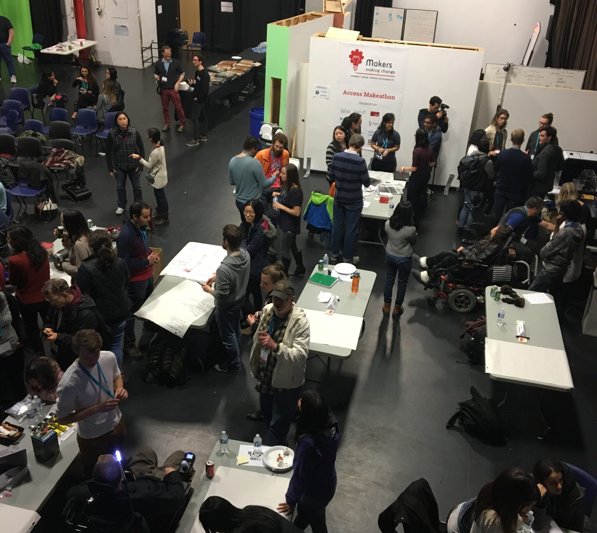 A wide shot of multiple groups working on their devices at the Access Makeathon