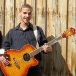 Digital Jumpstart participant Philippe playing his guitar
