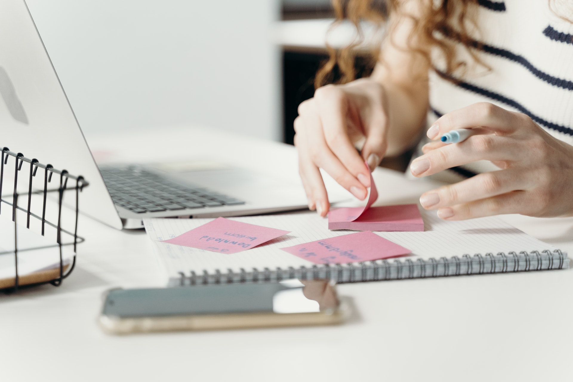 a woman writing on sticky notes