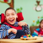 a child in a wheelchair smiling