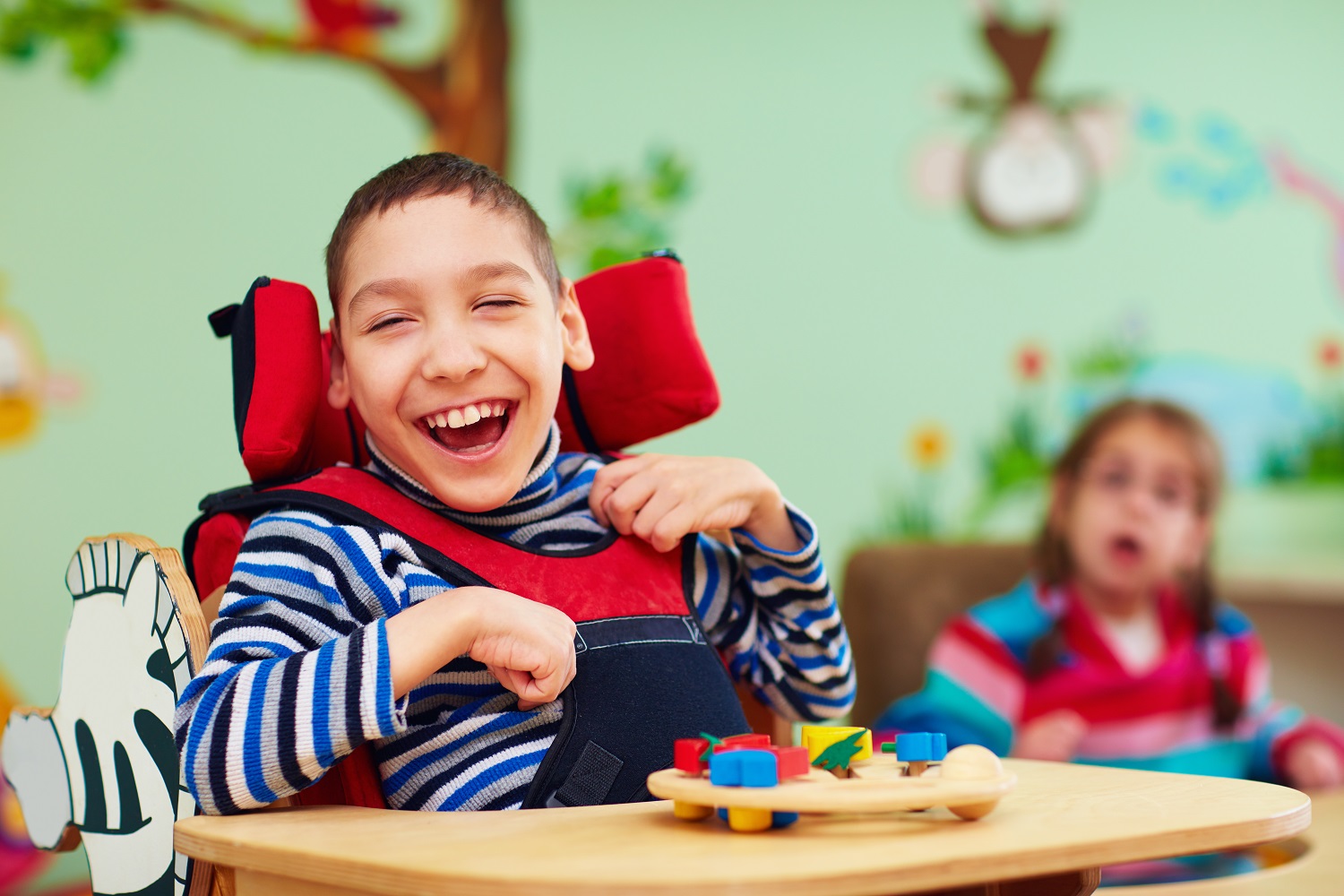 a child in a wheelchair smiling