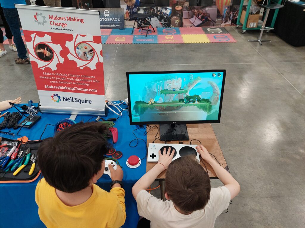 kids playing a game with an Xbox Adaptive Controller