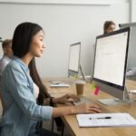 a woman typing an email in an office