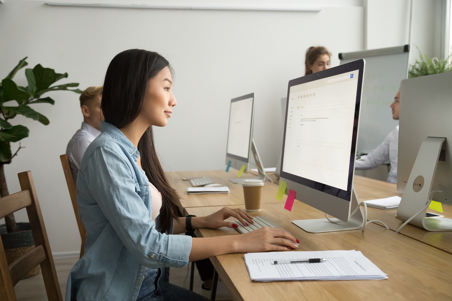 a woman typing an email in an office