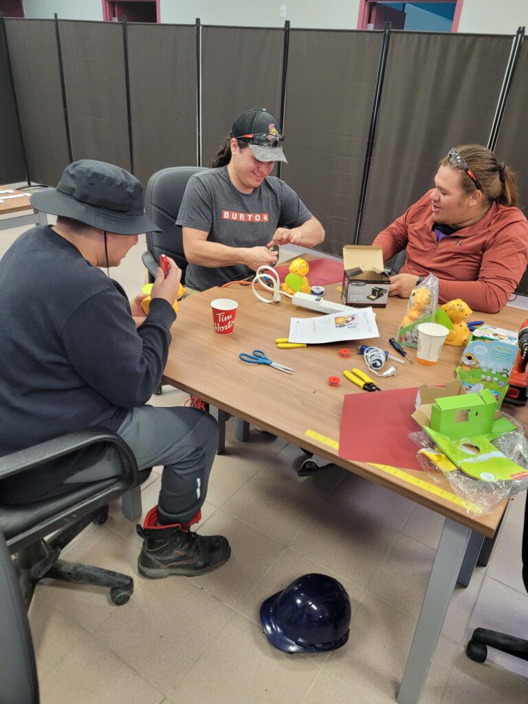 volunteers working together on switch adapted toys