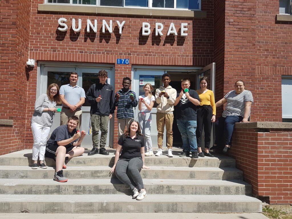 Sunny Brae students show off their switches outside the school building