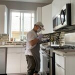 WorkBC Assistive Technology Services participant Eliezar cleaning a stove