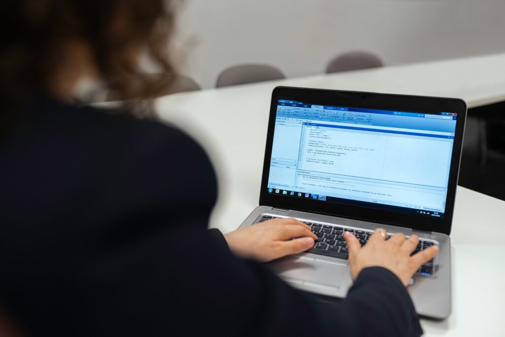 a person coding on a laptop