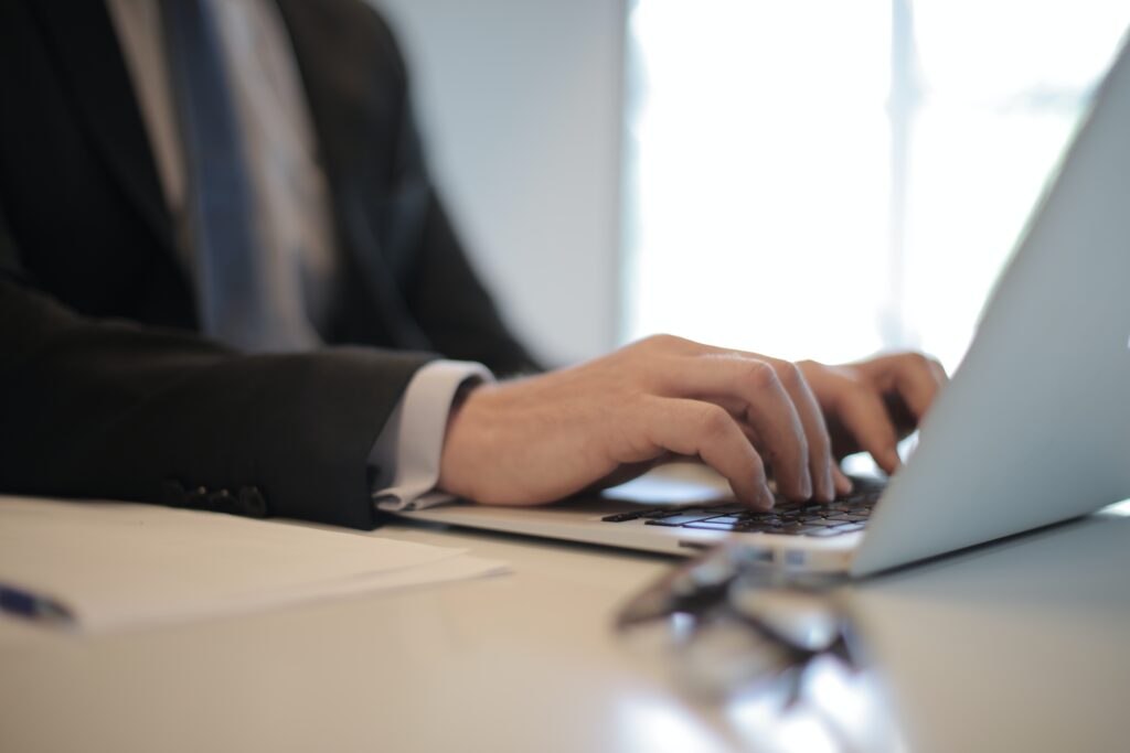 a man in a suit using a laptop