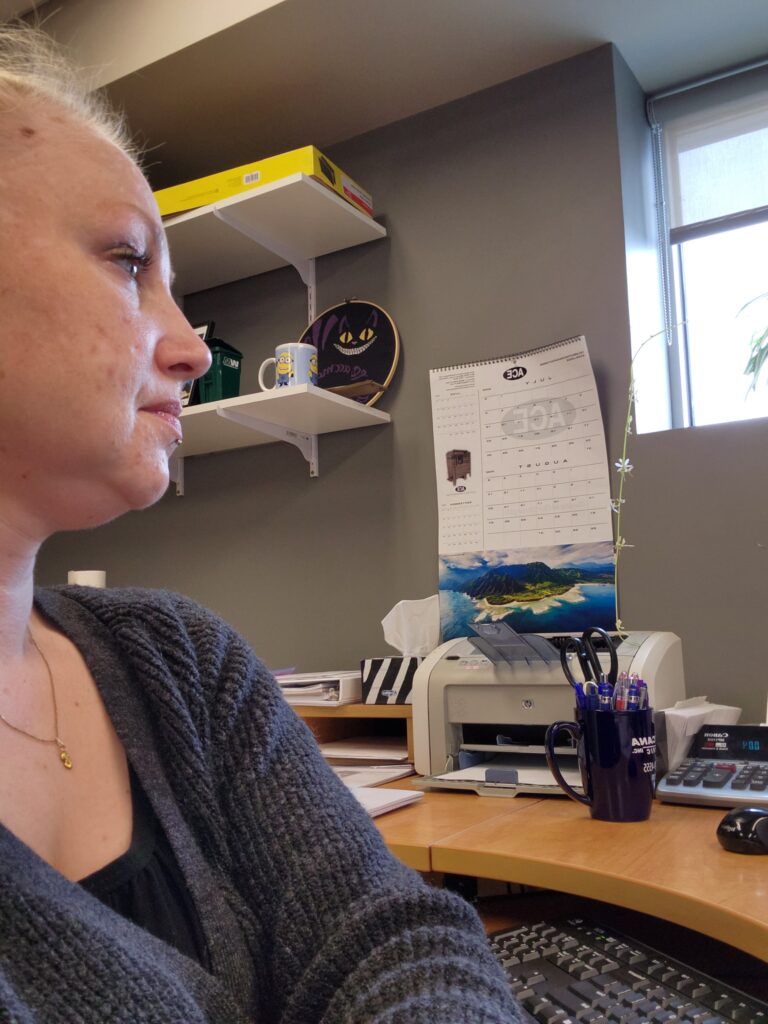 WorkBC Assistive Technology Services participant Miranda at her desk in an office