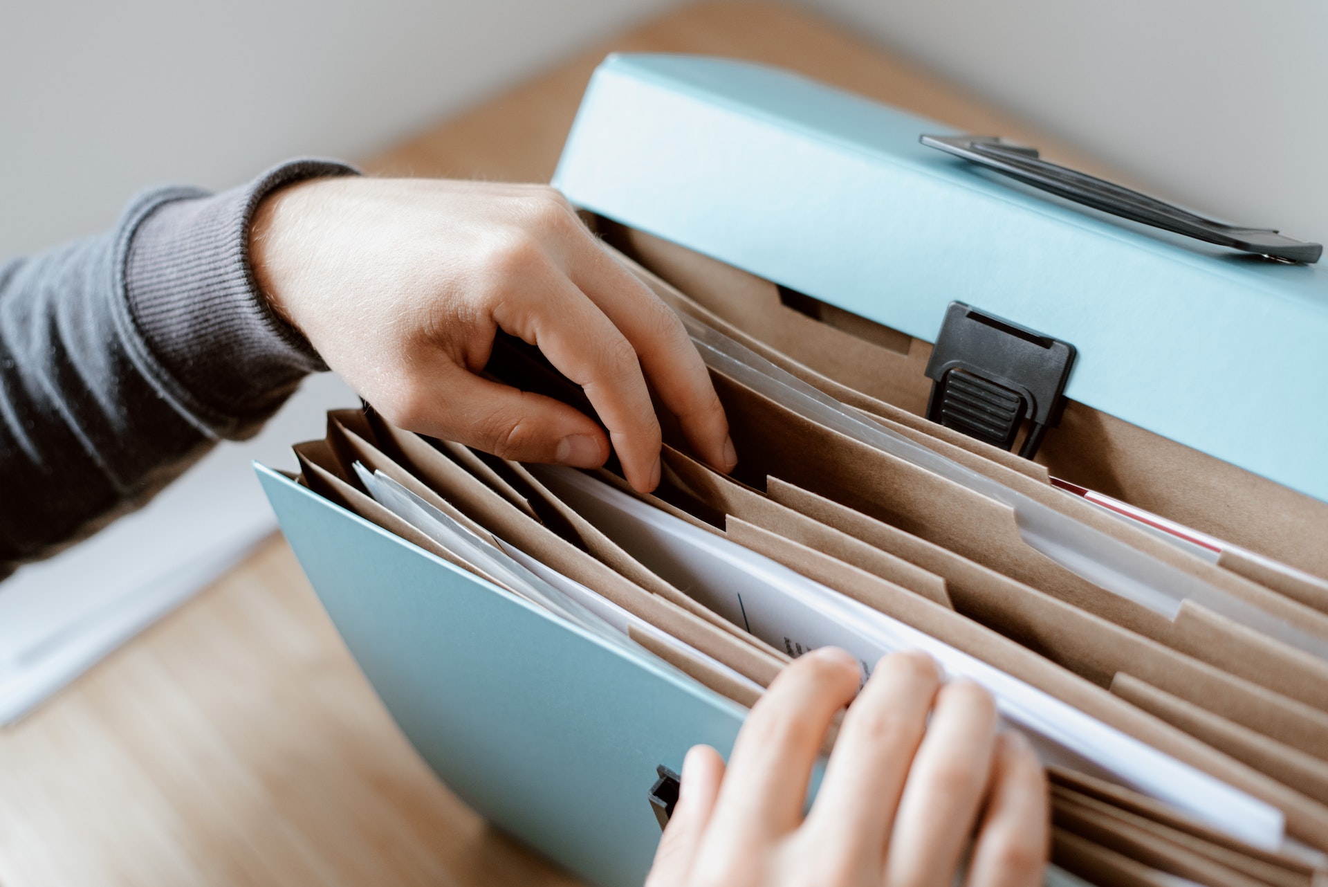 a person sorting through files in a folder