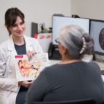 Audiologist Heather showing a picture of an ear to client