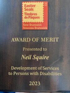 the award of merit presented to Neil Squire doe development of services to persons with disabilities