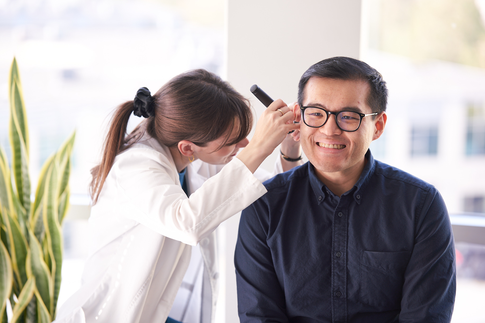 Neil Squire Hearing Solutions Audiologist Heather conducting a hearing exam with a client