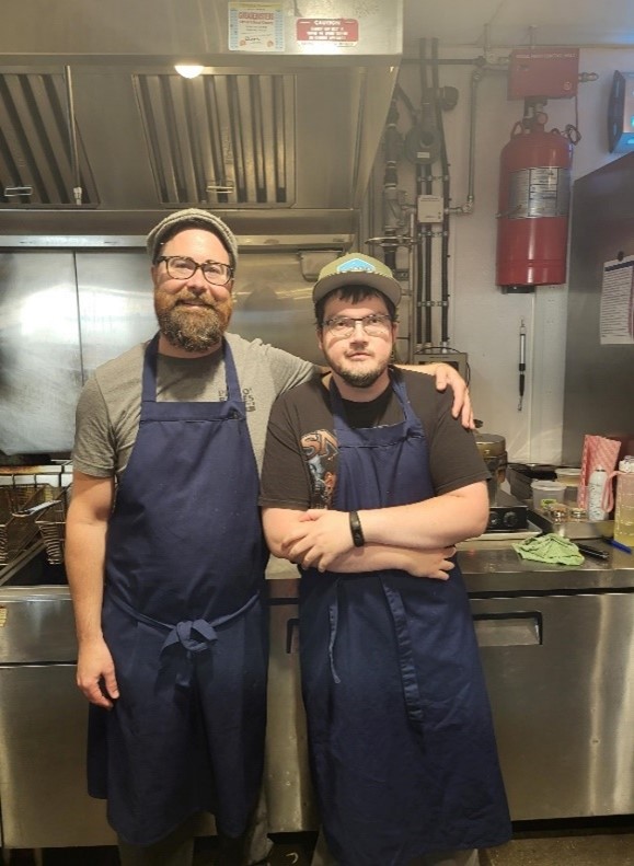 Creative Employment Options participant Stephen (right) in the kitchen with his employer.