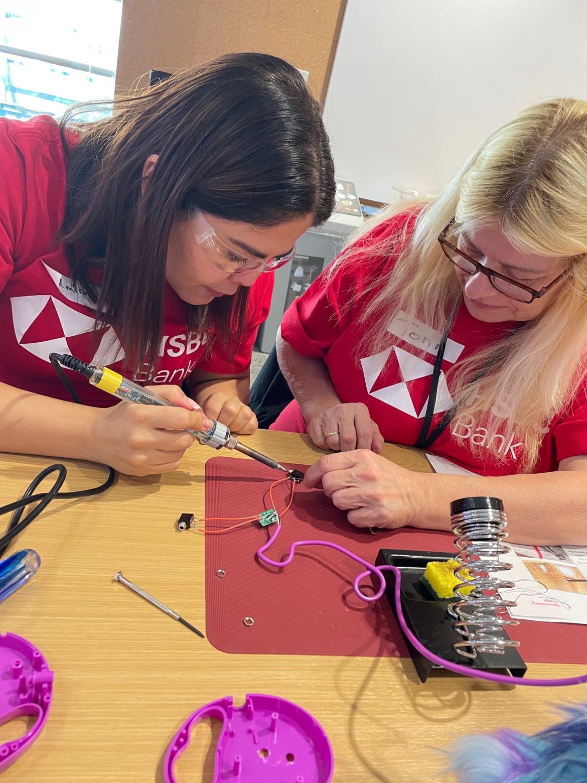 HSBC Bank Canada staff work together on soldering toys.