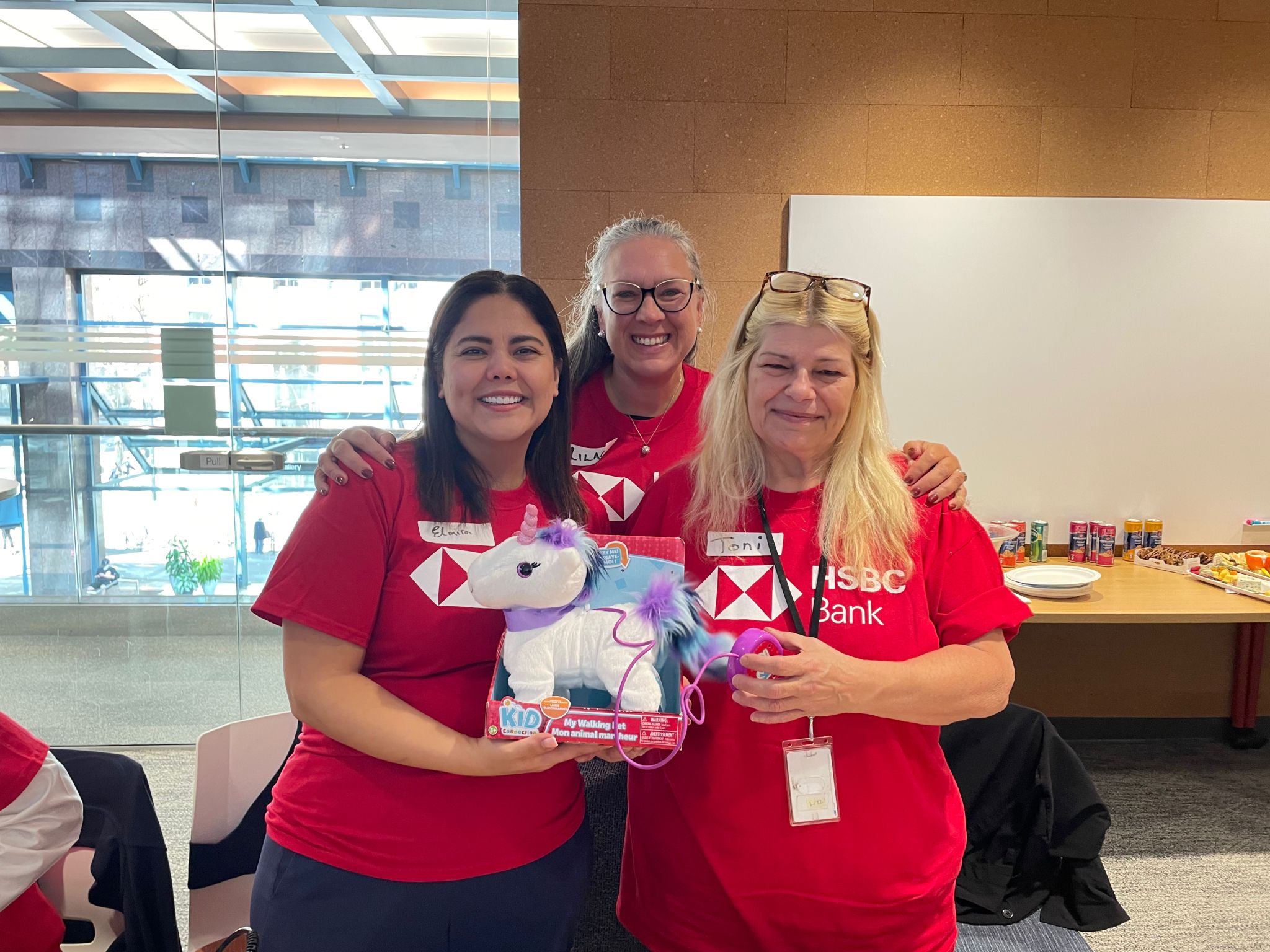 Three HSBC Bank Canada staff pose with their adapted toy.