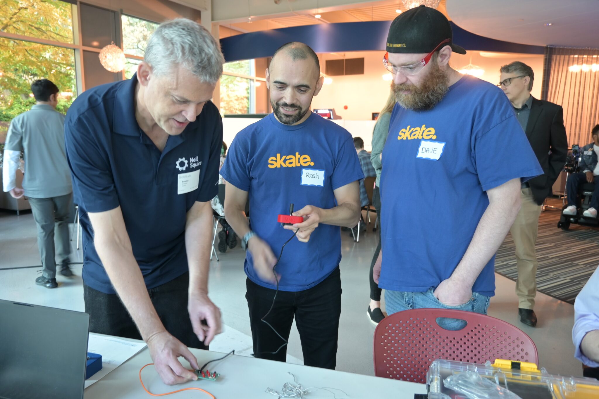 Neil Squire staff member Derrick tests the adaptive joysticks made by two members of the .skate team at Full Circle.