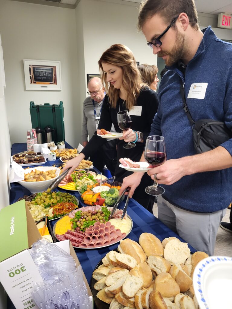 Guests fill their plates with food.