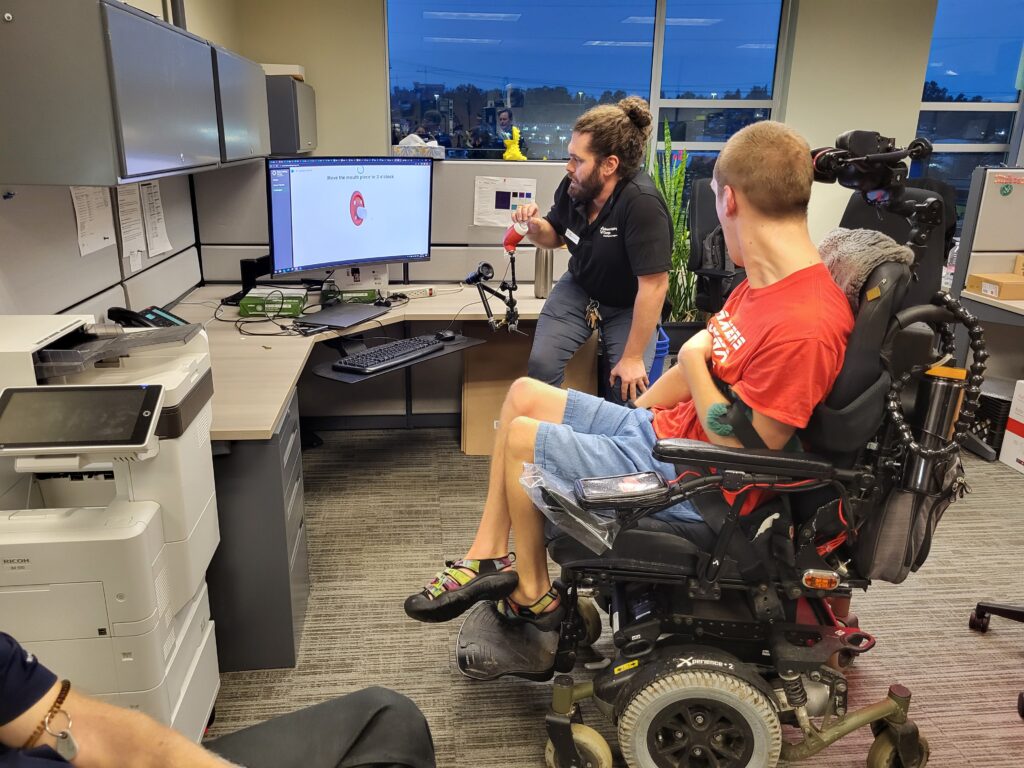 MMC team member Reed discusses with fellow team member Dan the LipSync they're working on.