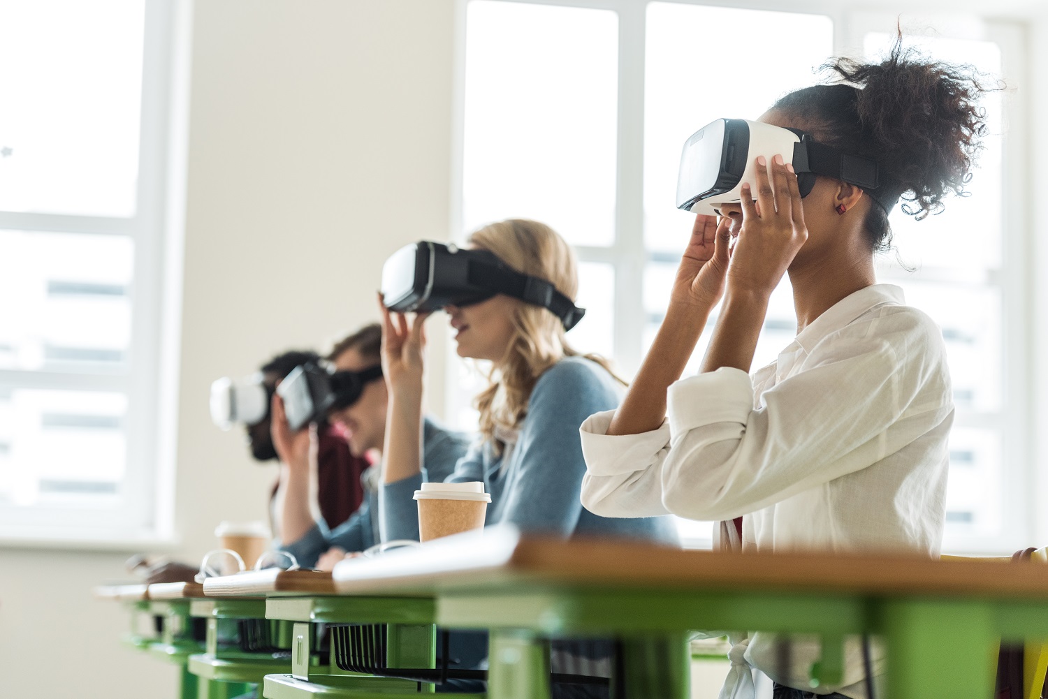 A row of people wearing VR headsets.