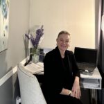 Digital Jumpstart participant Elana at her desk with her laptop.