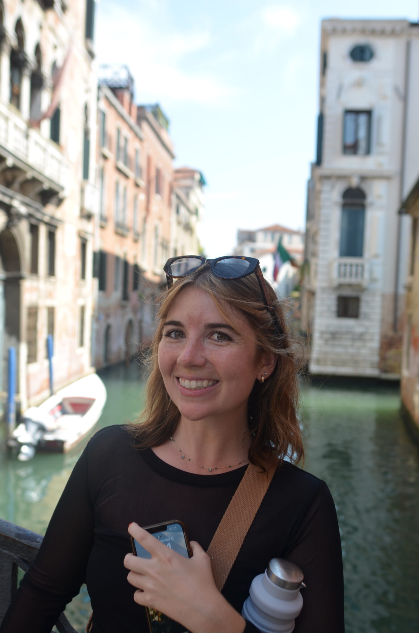 Hannah standing in front of a canal in Italy.