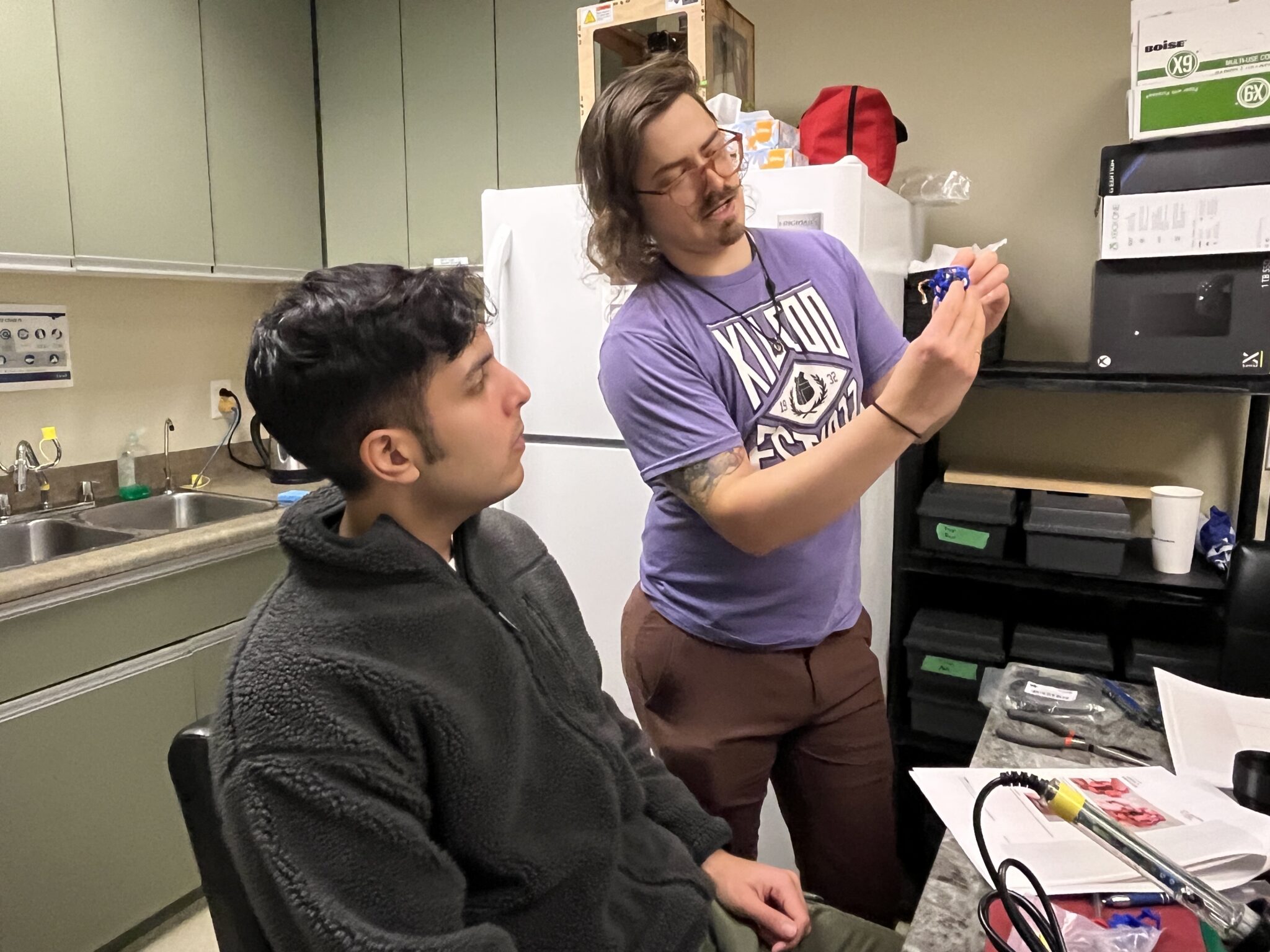 Stephan, from our R&D team, shows Kyle how to do a step in the build.